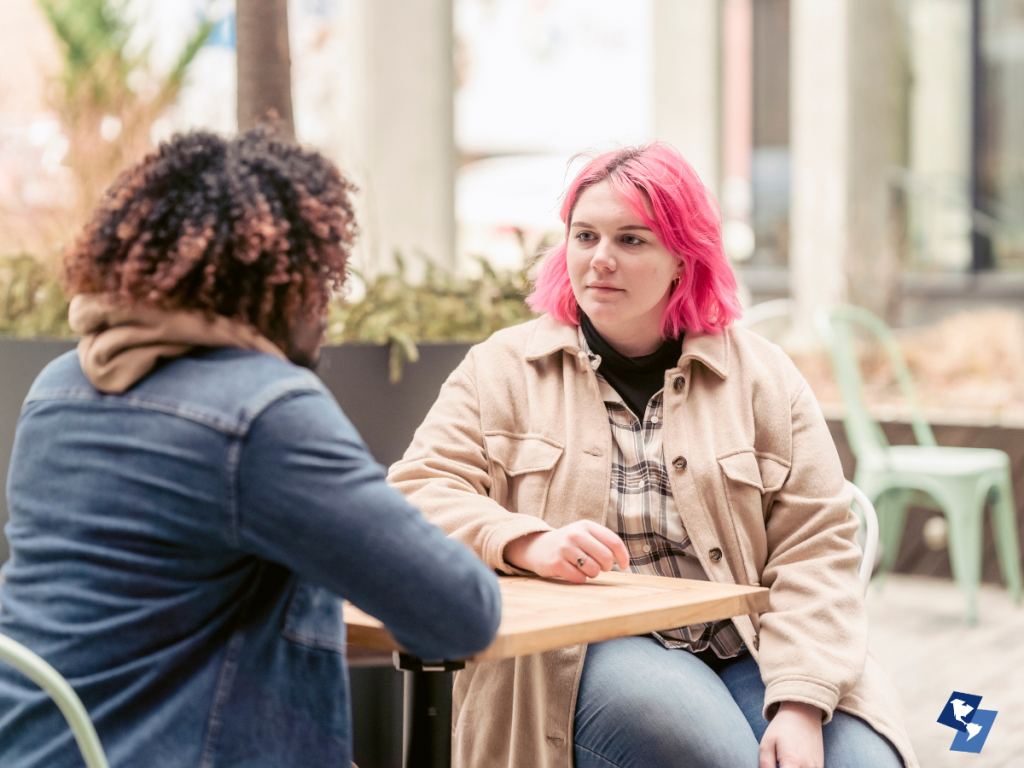 Friend listening with care during a Thanksgiving event.