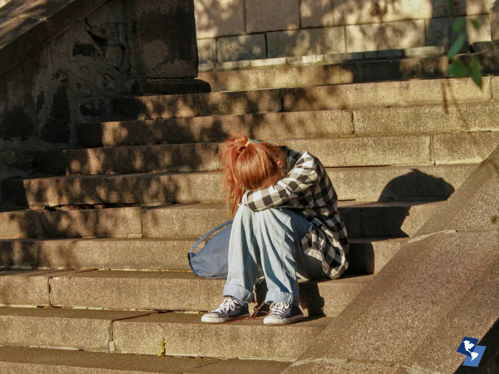Person praying quietly before a Thanksgiving outreach event.